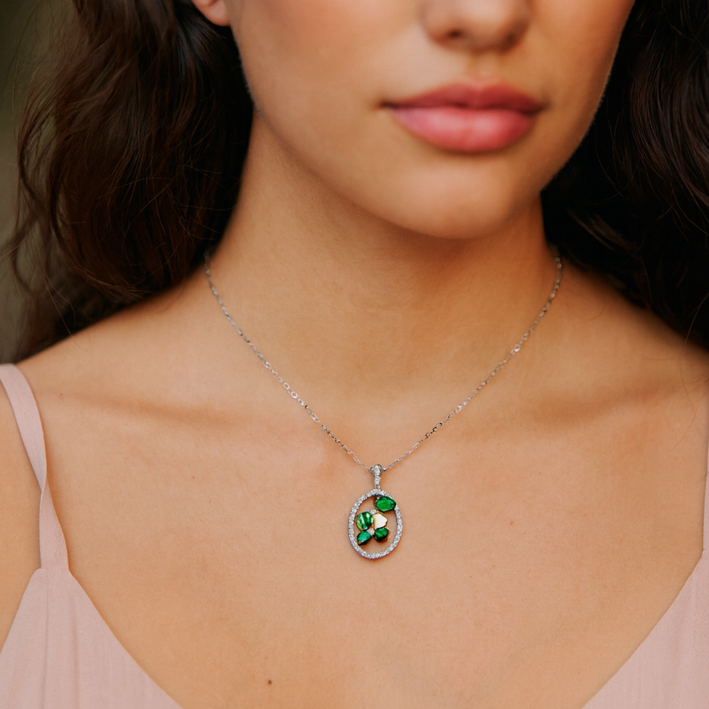 Oval Shaped White Gold Pendant with Emeralds