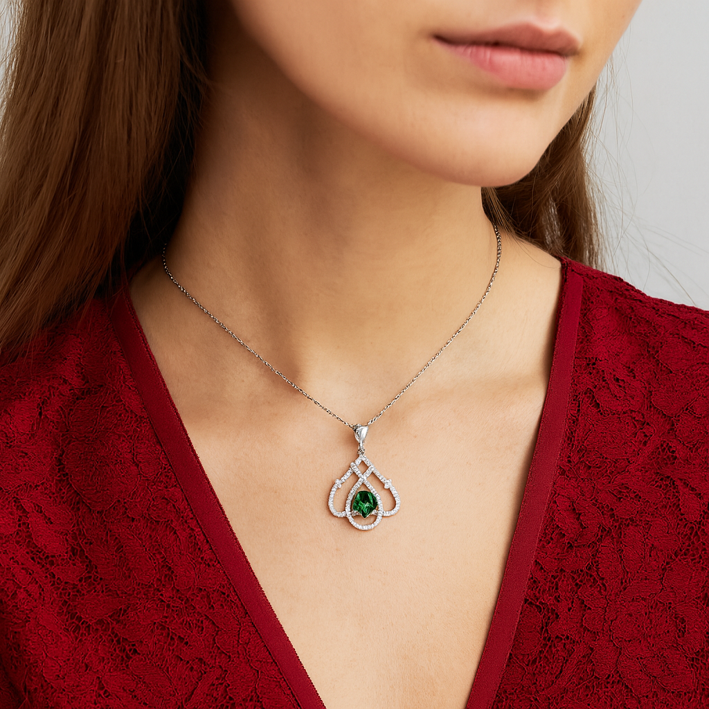 Teardrop Shaped White Gold Pendant With An Emerald