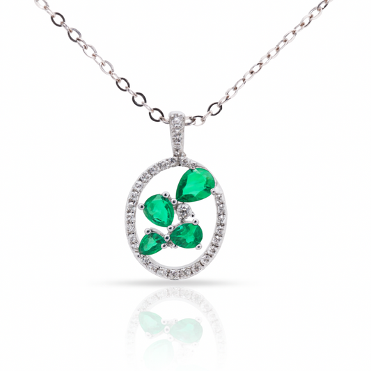 Pendentif en or blanc de forme ovale avec émeraudes